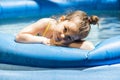 Adorable little girl playing at a outdoor swimming pool Royalty Free Stock Photo