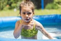 Adorable little girl playing at a outdoor swimming pool Royalty Free Stock Photo