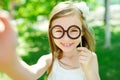 Adorable little girl playing with paper glasses on a stick Royalty Free Stock Photo