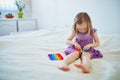 Adorable little girl playing with pop it fidget