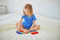 Adorable little girl playing with pop it fidget