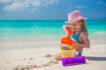 Adorable little girl playing with sand on a Royalty Free Stock Photo