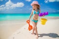 Adorable little girl playing with sand on a Royalty Free Stock Photo