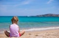 Adorable little girl playing with sand at white