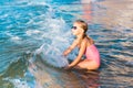 Adorable little girl playing in the sea on a beach Royalty Free Stock Photo