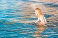 Adorable little girl playing in the sea on a beach Royalty Free Stock Photo