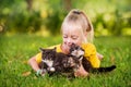 Little girl playing with small kittens at warm and sunny summer day Royalty Free Stock Photo