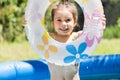 Adorable little girl playing at a swimming pool Royalty Free Stock Photo