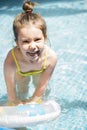 Adorable little girl playing at a swimming pool Royalty Free Stock Photo