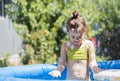 Adorable little girl playing at a swimming pool Royalty Free Stock Photo