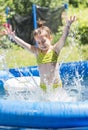 Adorable little girl playing at a swimming pool Royalty Free Stock Photo