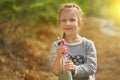 Adorable little girl playing with water gun on hot summer day. Cute child having fun with water outdoors. Funny summer Royalty Free Stock Photo