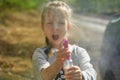 Adorable little girl playing with water gun on hot summer day. Cute child having fun with water outdoors. Funny summer Royalty Free Stock Photo