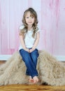 Adorable little girl posing on brown fur rug