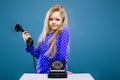 Adorable little girl in purple dress holds phone handset Royalty Free Stock Photo