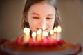 Adorable little girl and a raspberry cake