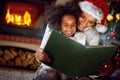 Adorable little girl reading fairytales with mom Royalty Free Stock Photo