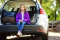 Adorable little girl ready to go on vacations with her parents. Kid relaxing in a car before a road trip.