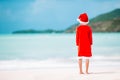 Adorable little girl in Santa hat on tropical beach Royalty Free Stock Photo