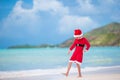 Adorable little girl in Santa hat on tropical beach Royalty Free Stock Photo