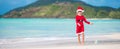 Adorable little girl in Santa hat on tropical beach Royalty Free Stock Photo
