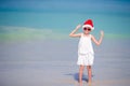 Adorable little girl in Santa hat on tropical beach Royalty Free Stock Photo