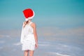 Adorable little girl in Santa hat on tropical beach Royalty Free Stock Photo