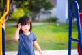 Adorable little girl is scratching her head  itchy the head from playing on a hot day and sweating. Royalty Free Stock Photo
