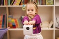 Adorable little girl shopping for toys. Cute female in toy store. Happy young girl selecting toy