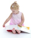 Adorable little girl sitting barefoot on the floor Royalty Free Stock Photo