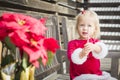 Adorable Little Girl Sitting On Bench with Her Candy Cane Royalty Free Stock Photo