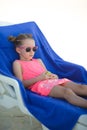 Adorable little girl sitting on chair at tropical Royalty Free Stock Photo