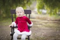 Adorable Little Girl Sitting in Her Chair Outside Royalty Free Stock Photo