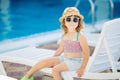 Adorable little girl sitting near the swimming pool Royalty Free Stock Photo