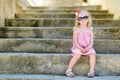 Adorable little girl sitting on stairs Royalty Free Stock Photo