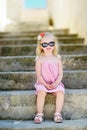Adorable little girl sitting on stairs Royalty Free Stock Photo