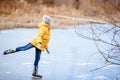 Adorable little girl skating on the ice-rink Royalty Free Stock Photo