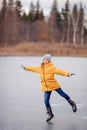 Adorable little girl skating on the ice-rink Royalty Free Stock Photo