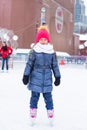 Adorable little girl skating on the ice rink Royalty Free Stock Photo