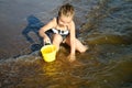 Adorable little girl is splashing and smashing sea water and having fun Royalty Free Stock Photo