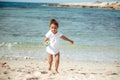 Adorable little girl splashing in tropical shallow water during summer vacation Royalty Free Stock Photo