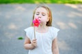 Adorable little girl in summer day holds windmill in hand Royalty Free Stock Photo