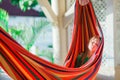 Adorable little girl on tropical vacation relaxing in hammock Royalty Free Stock Photo