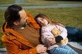 Loving father looking at his cute sleeping daughter