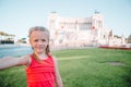 Adorable little girl taking selfie in front of Altare della Patria, Vittoriano, Rome, Italy. Royalty Free Stock Photo