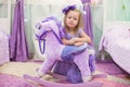 Adorable little girl with a toy horse at home Royalty Free Stock Photo