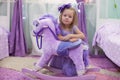 Adorable little girl with a toy horse at home Royalty Free Stock Photo