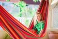 Adorable little girl on tropical vacation relaxing in hammock Royalty Free Stock Photo