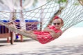 Adorable little girl on tropical vacation relaxing in hammock Royalty Free Stock Photo