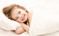 Adorable little girl waked up in her bed